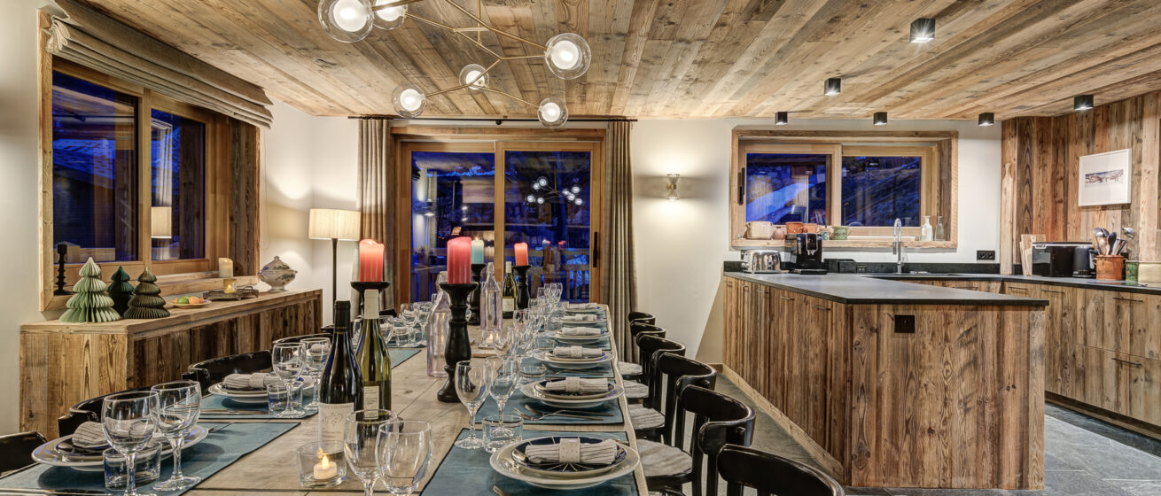 Chalet Bergeronnette, Meribel - open-plan kitchen with dining table set for dinner